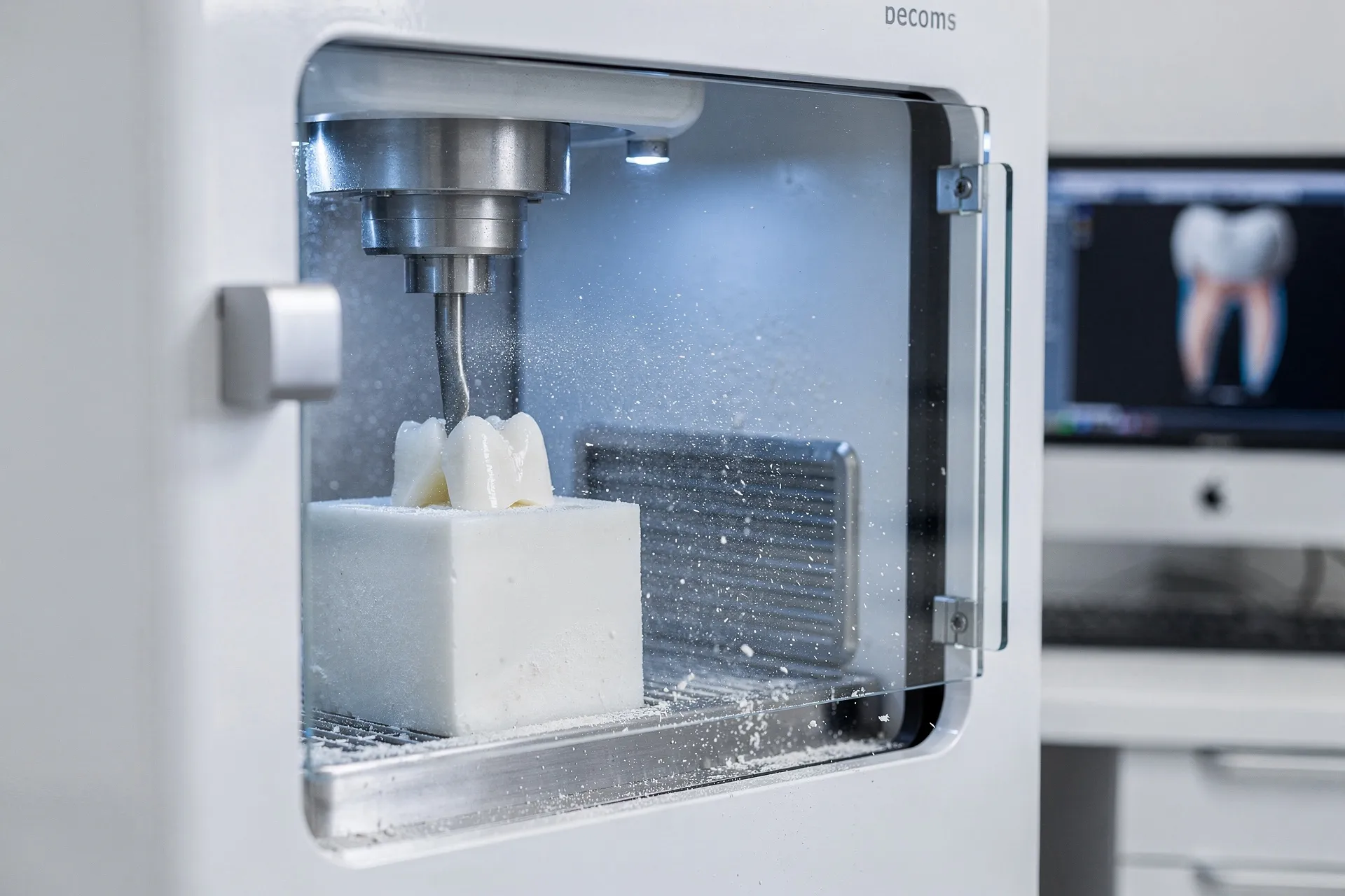 CAD/CAM machine milling a zirconia restoration in the in-house lab