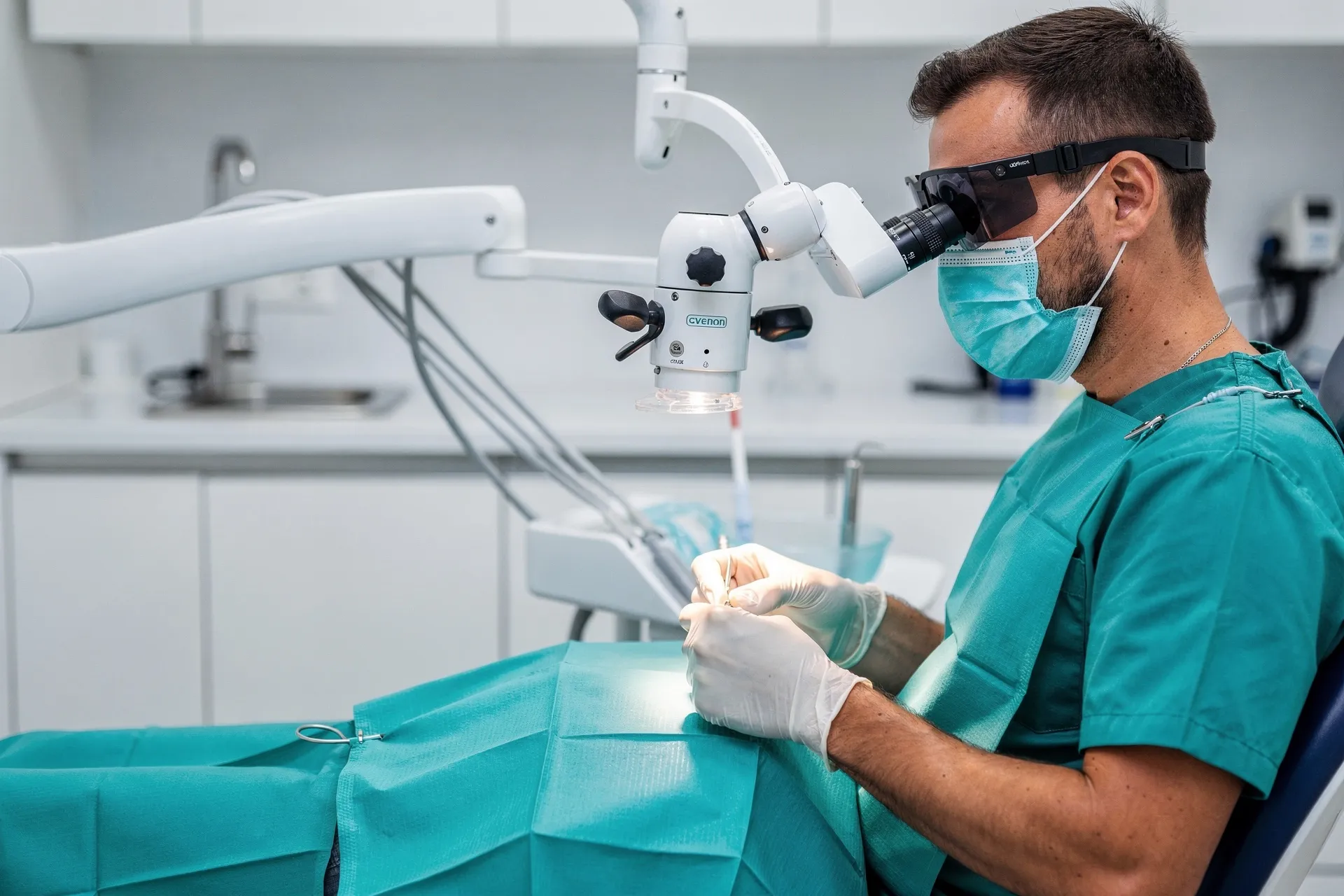 Dentist performing root canal treatment under an operating microscope